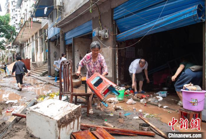 7月4日，萬(wàn)州區(qū)五橋街道，洪水退去后，居民搶救生活物資?！∪矫宪?攝