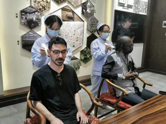 2023“一帶一路”媒體合作論壇聯(lián)合采訪團(tuán)團(tuán)員在九牛草展示館體驗(yàn)艾灸。（本報(bào)記者 黃超攝）