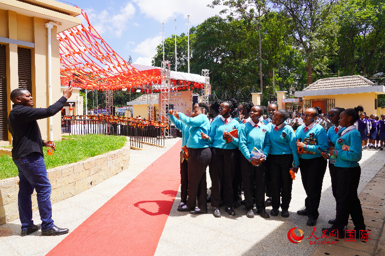 一名老師在給學生拍照留念。人民網(wǎng)記者 黃煒鑫攝