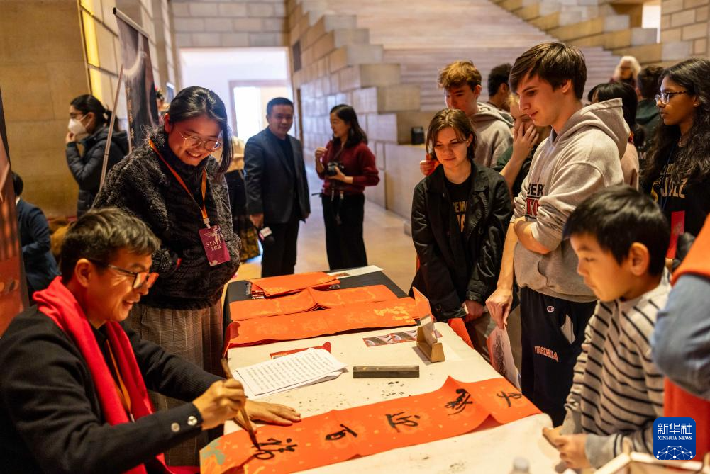 2月11日，書(shū)法家在美國(guó)費(fèi)城藝術(shù)博物館舉行的龍年迎新春活動(dòng)上為參觀者書(shū)寫(xiě)對(duì)聯(lián)。新華社發(fā)（周煥新攝）