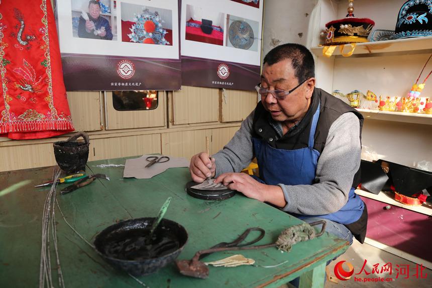 戲曲盔頭技藝傳承人許茂臣正在足活。 韓冰攝