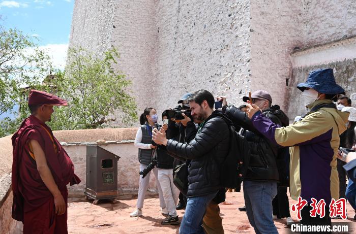 圖為中外媒體拍攝朝拜布達(dá)拉宮的僧人。　趙朗 攝