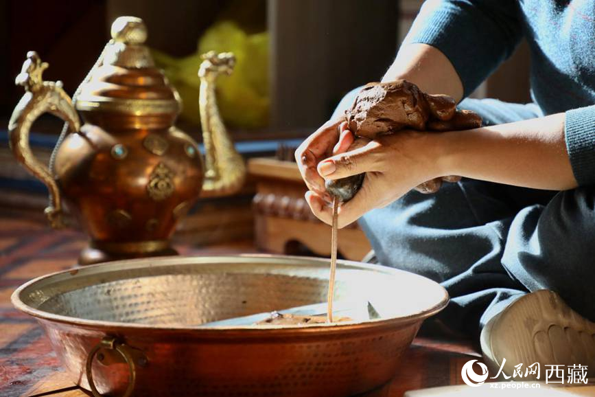 牛角鉆孔，將木泥擠出。人民網(wǎng)記者 次仁羅布攝