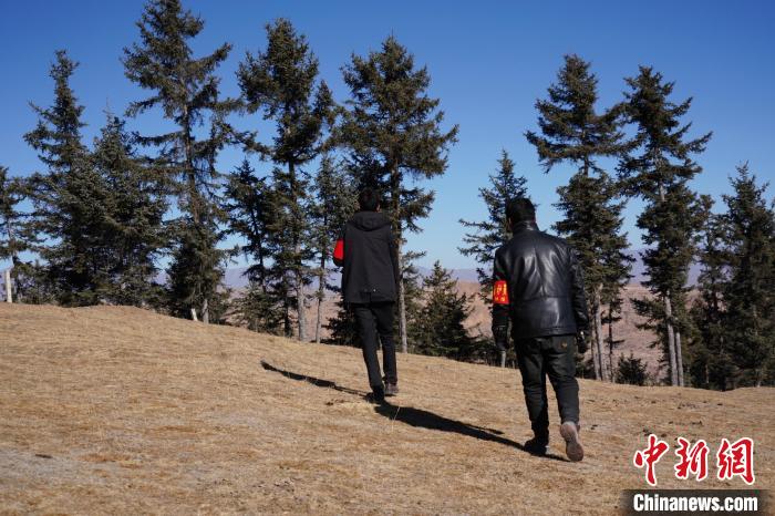 圖為桑杰加(左)和同事巡查林場?！●R銘言 攝