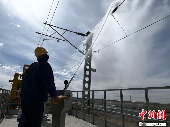 圖為高壓水槍的水柱沖洗絕緣子串。　高啟宏 攝