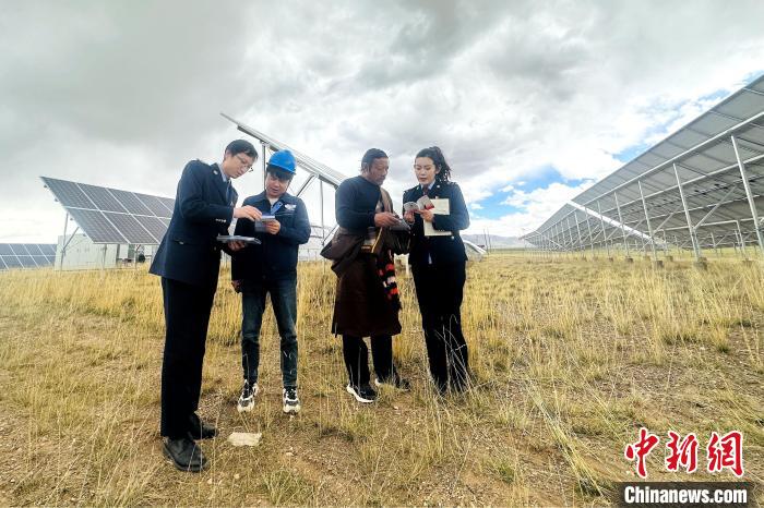 圖為稅務(wù)干部上門開展稅費(fèi)輔導(dǎo)?！》劫F龍 攝