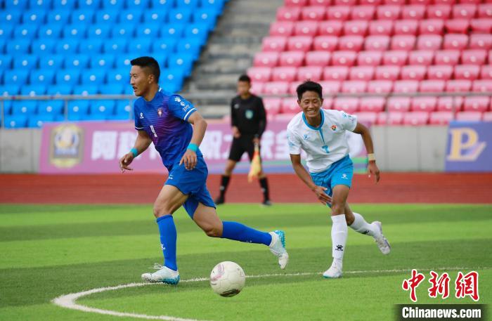 圖為班瑪隊(白)與達(dá)日隊隊員在球場感受快樂足球?！●R銘言 攝