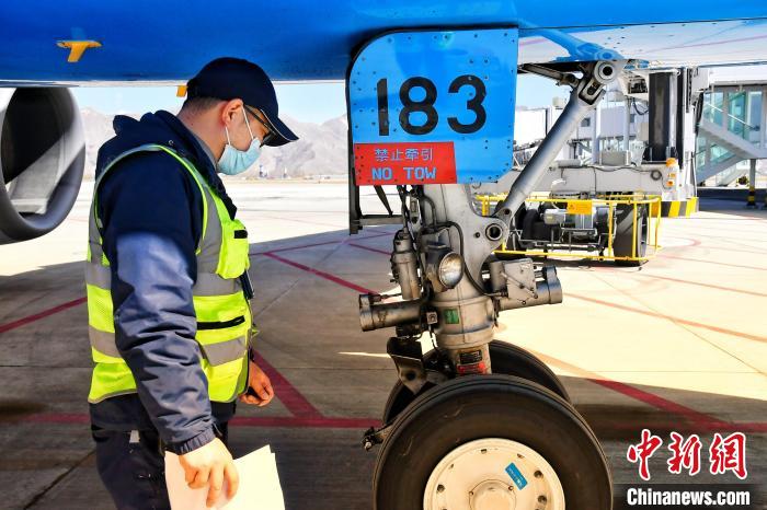 圖為機(jī)場(chǎng)工作人員進(jìn)行相關(guān)檢查?！≈芎?攝