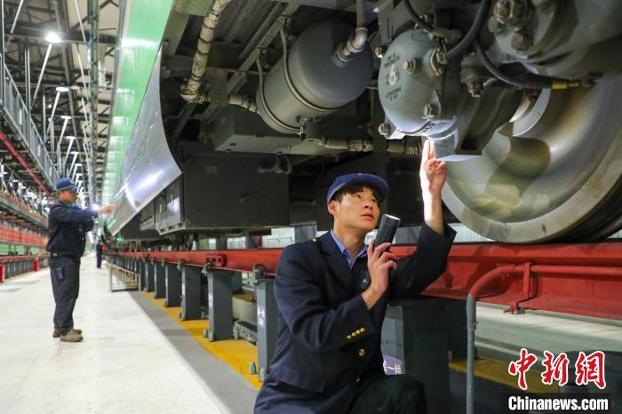 圖為工作人員檢查高原復(fù)興號?！≈軔傁?攝